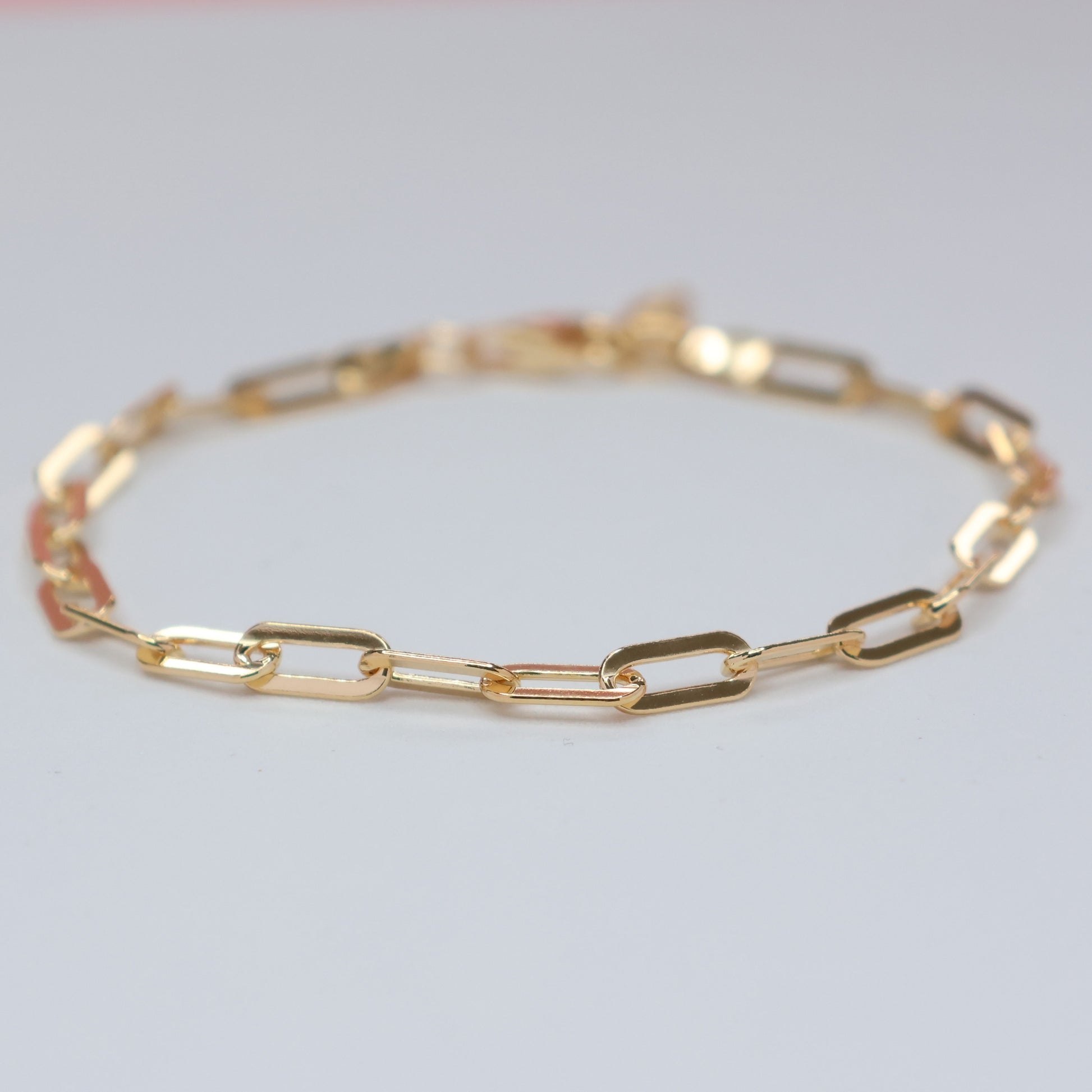 Elegant gold plated paperclip bracelet featuring a modern design for stylish accessorizing