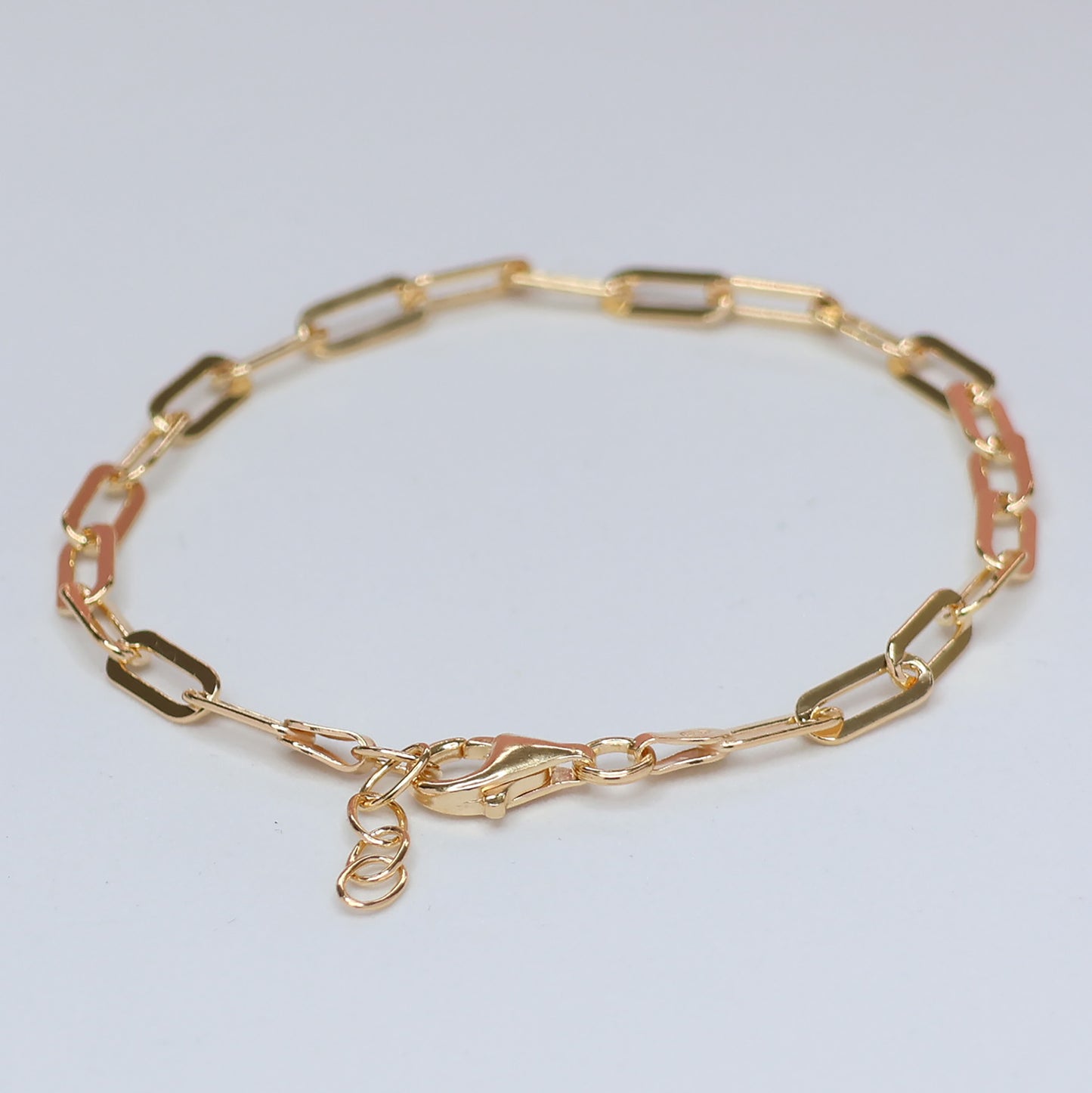 Elegant gold plated paperclip bracelet featuring a modern design and secure clasp