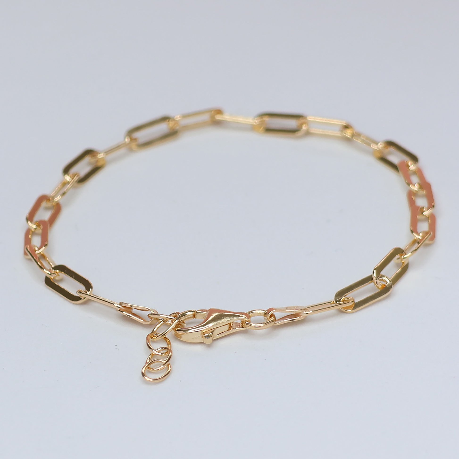 Elegant gold plated paperclip bracelet featuring a modern design and secure clasp