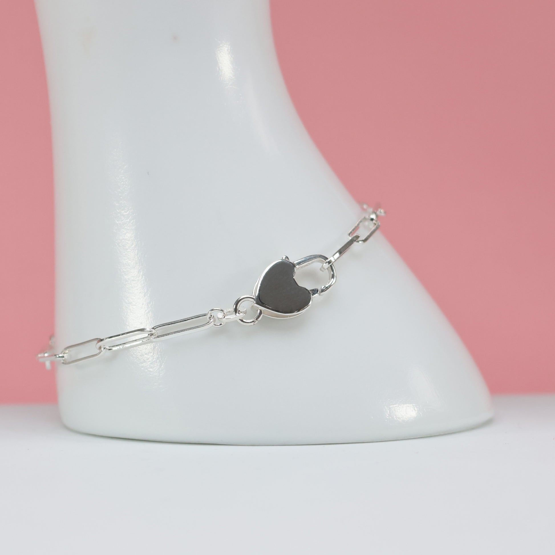 Heart clasp silver bracelet featuring a stylish heart-shaped closure and delicate chain links