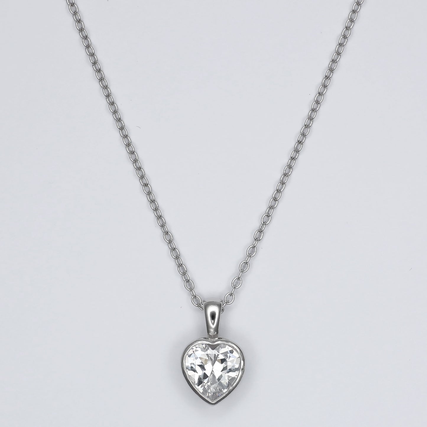 Elegant heart shape silver pendant with sparkling gemstone, perfect for any occasion