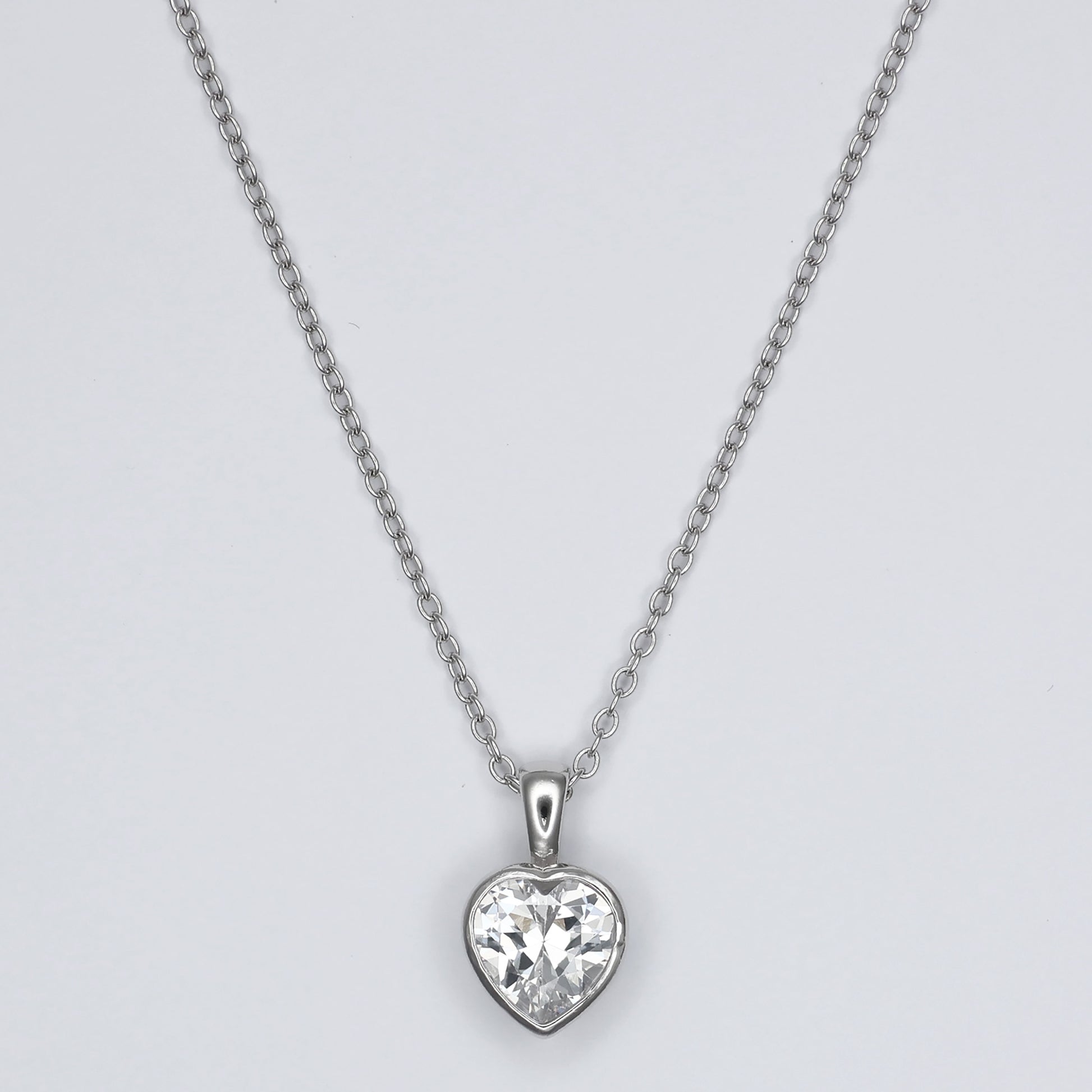 Elegant heart shape silver pendant with sparkling gemstone, perfect for any occasion