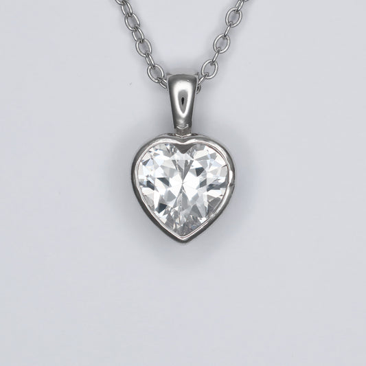 Heart shape silver pendant featuring a sparkling clear gemstone on a delicate chain