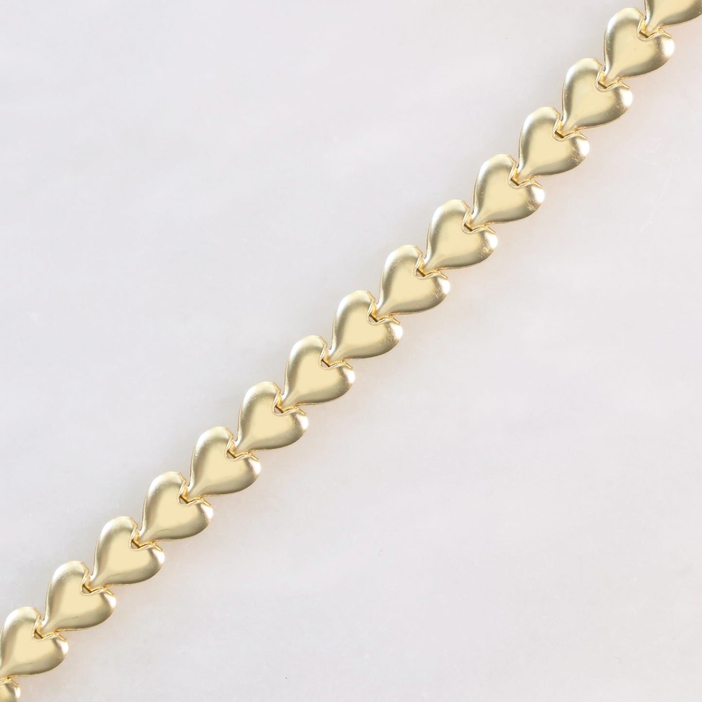 Elegant heart link bracelet for her featuring a gold finish with interlocking heart designs