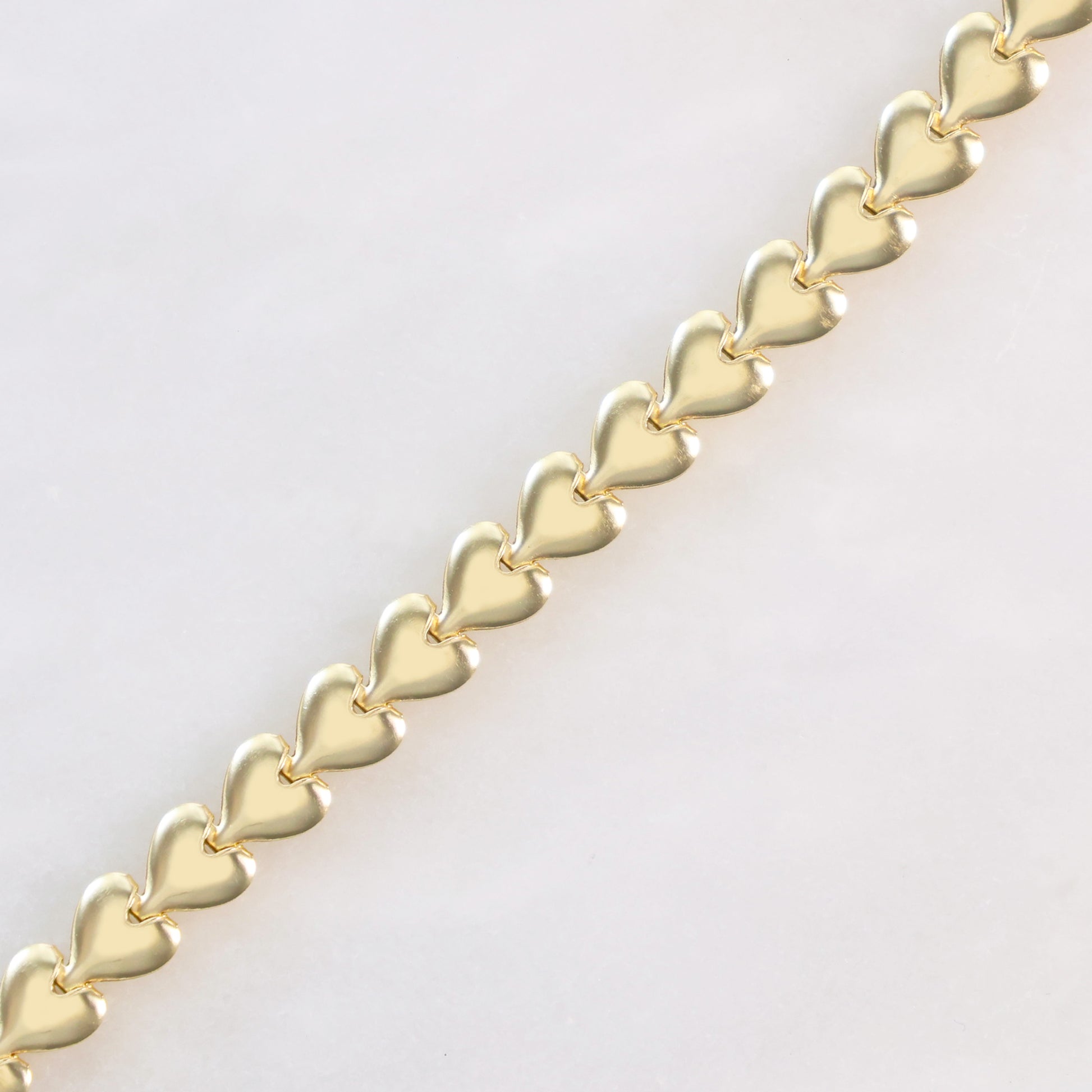 Elegant heart link bracelet for her featuring a gold finish with interlocking heart designs