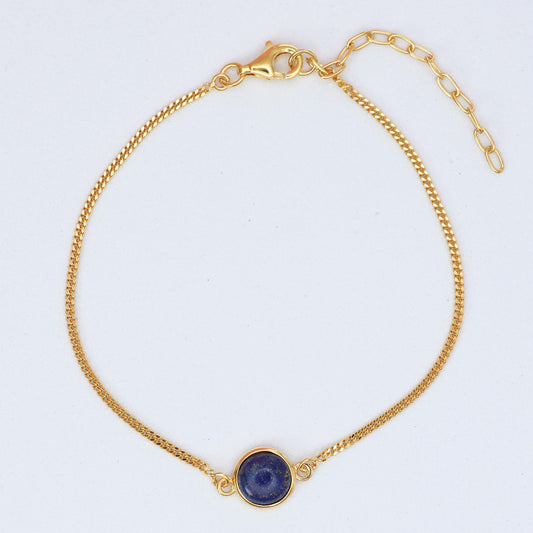 Elegant gold chain bracelet featuring a round lapis stone bracelet centerpiece for a stylish look