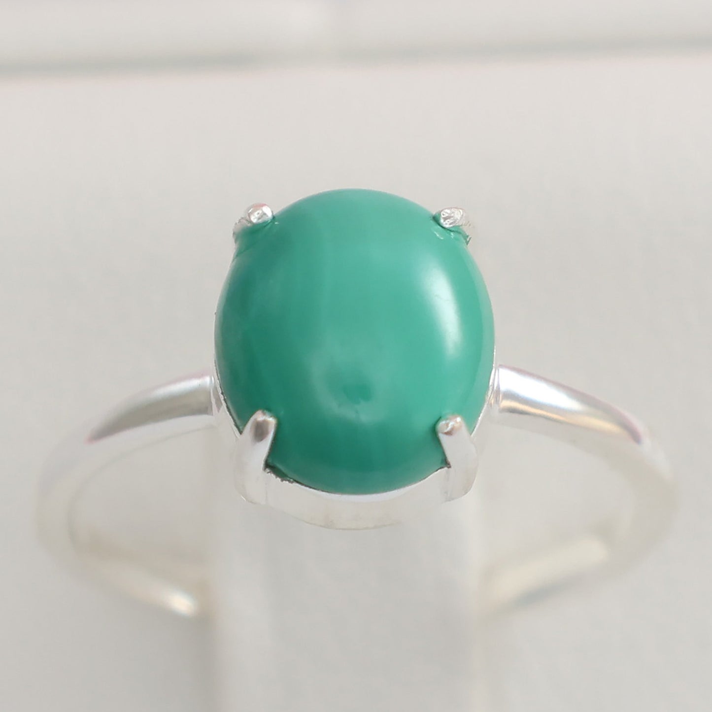 Large malachite stone ring with a silver band showcasing the vibrant green hue of the stone