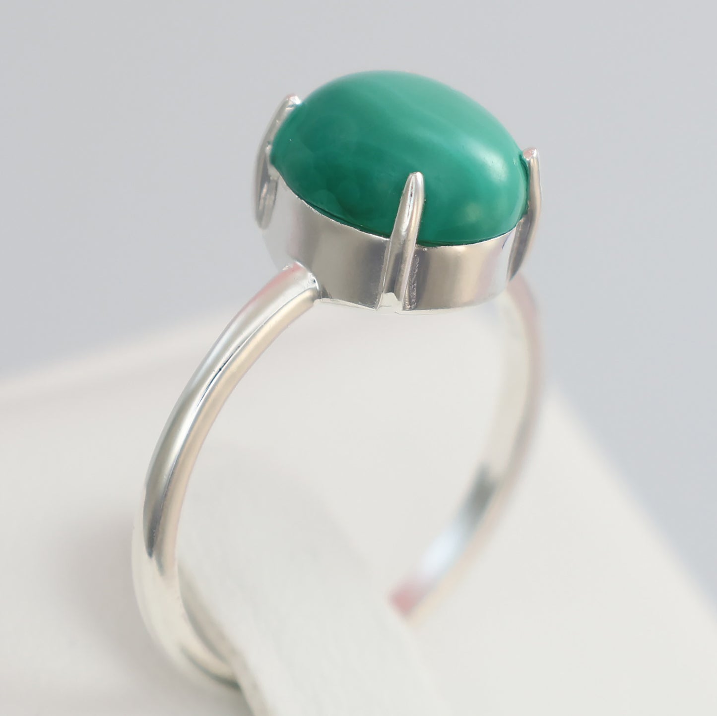 Large malachite stone ring set in silver with a sleek design and polished finish