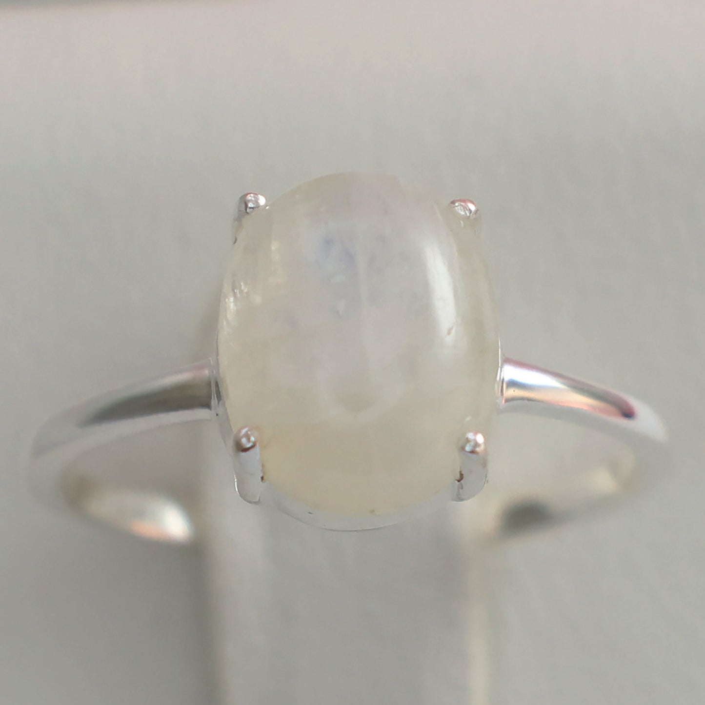 Large moonstone silver ring featuring a smooth oval moonstone on a polished silver band