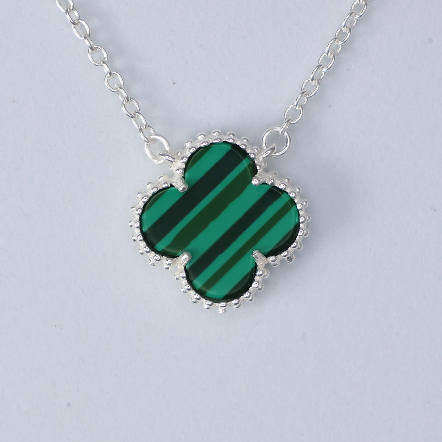 Malachite Clover Necklace featuring a green striped gem set in a silver chain design