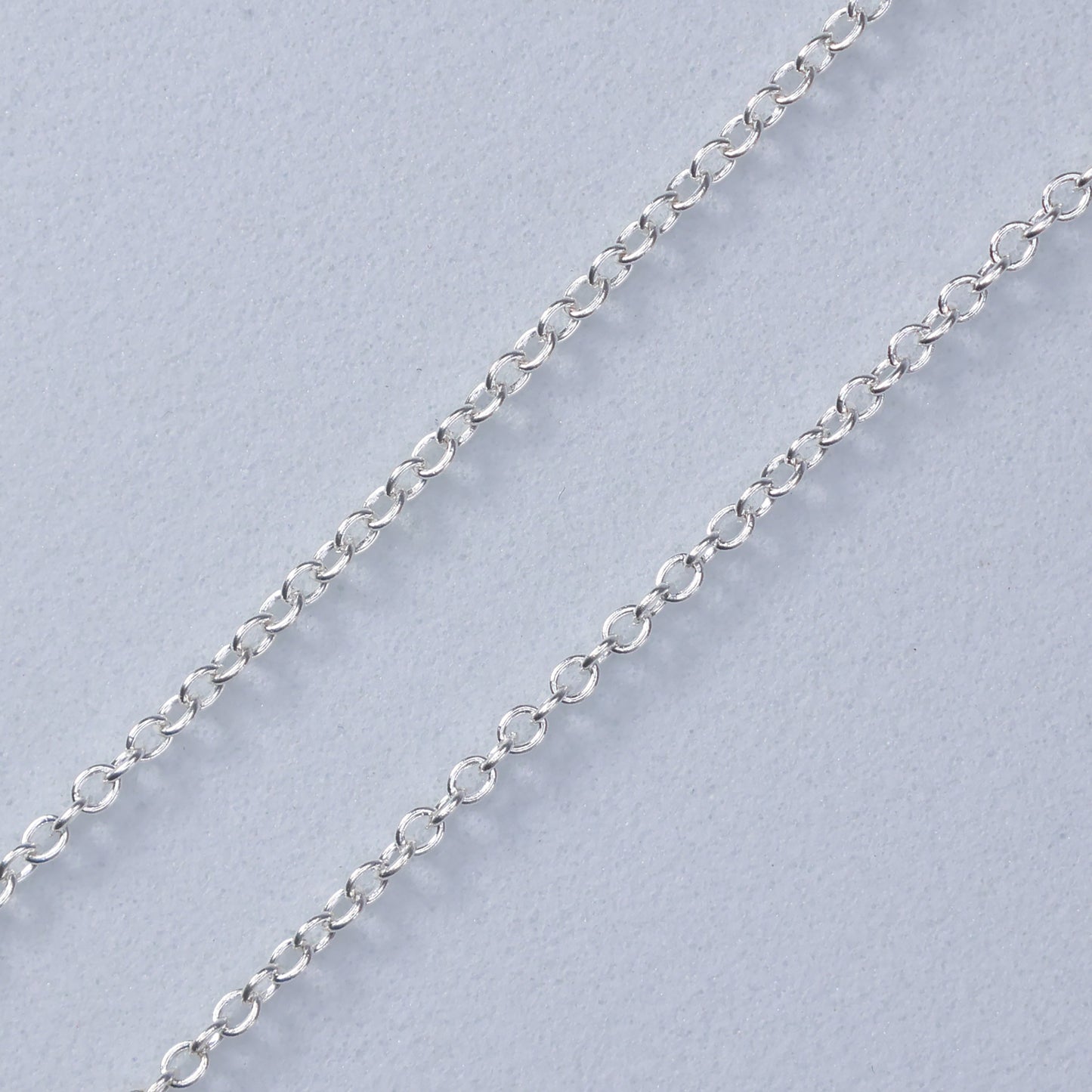 Close-up of the delicate chain of a Malachite Clover Necklace from thejewelleryshop.co.uk
