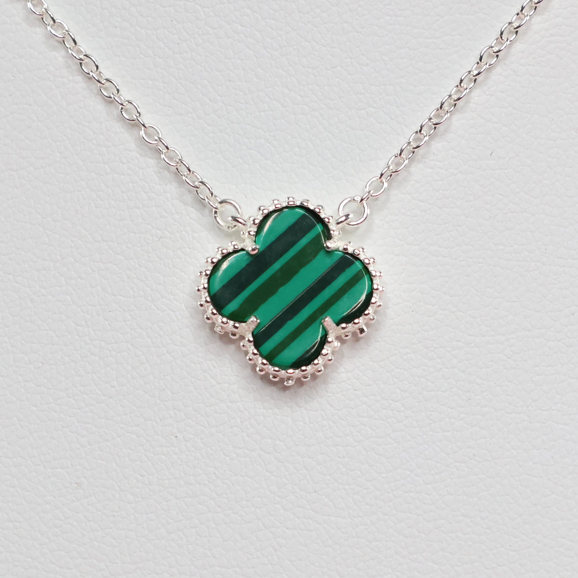 Malachite Clover Necklace with a distinctive green clover pendant on a delicate silver chain