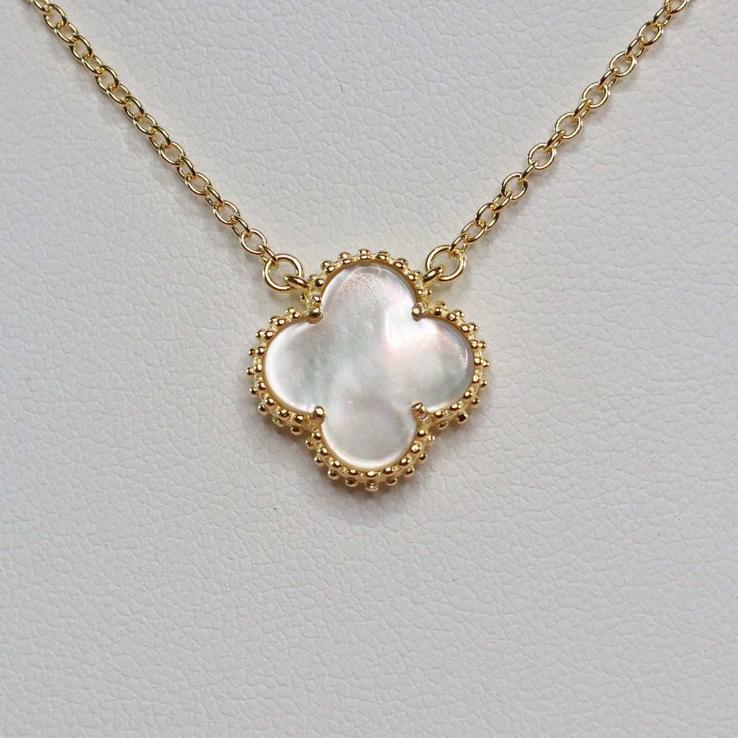 Elegant Mother of Pearl Clover Necklace featuring a gold chain and clover charm