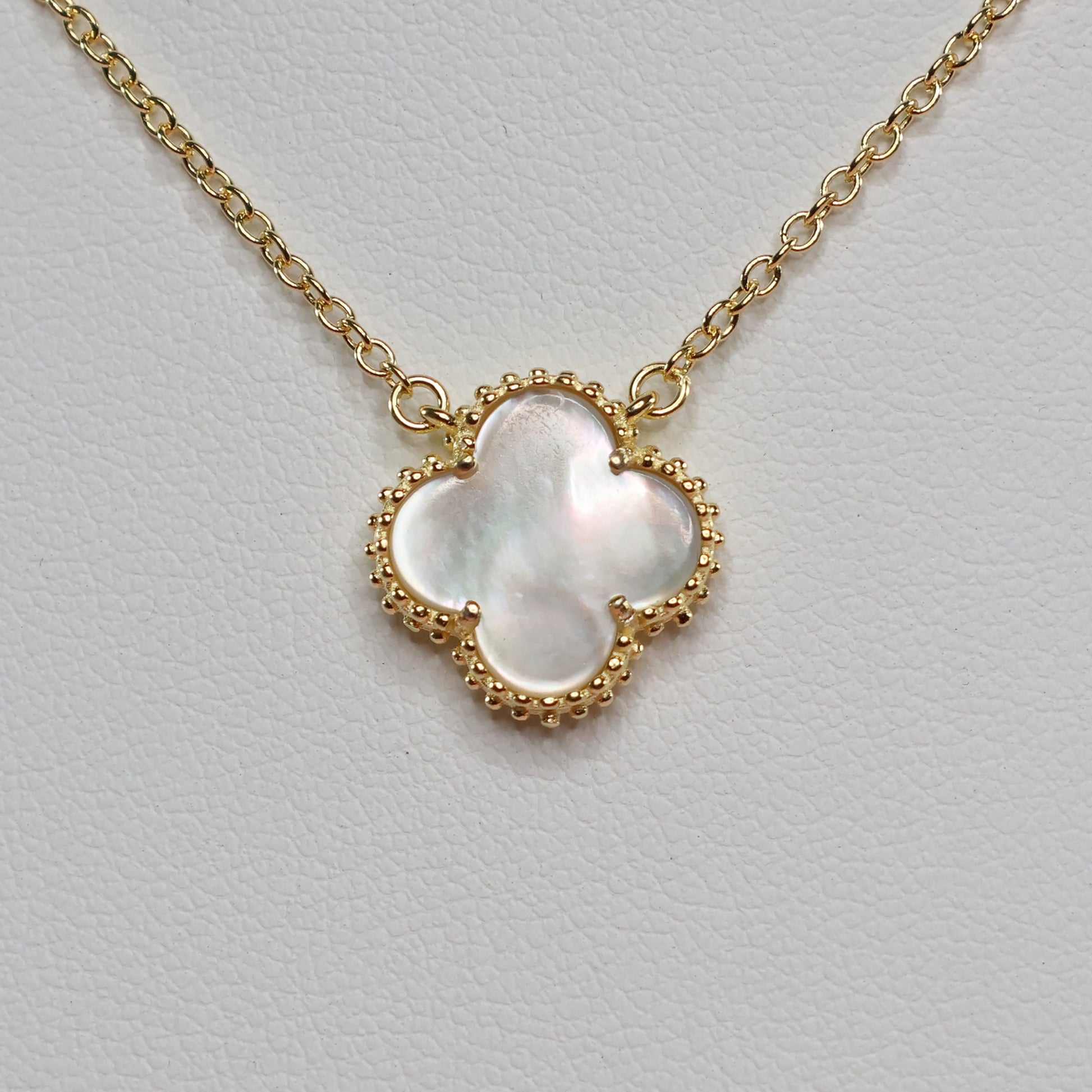 Elegant Mother of Pearl Clover Necklace featuring a gold chain and clover charm