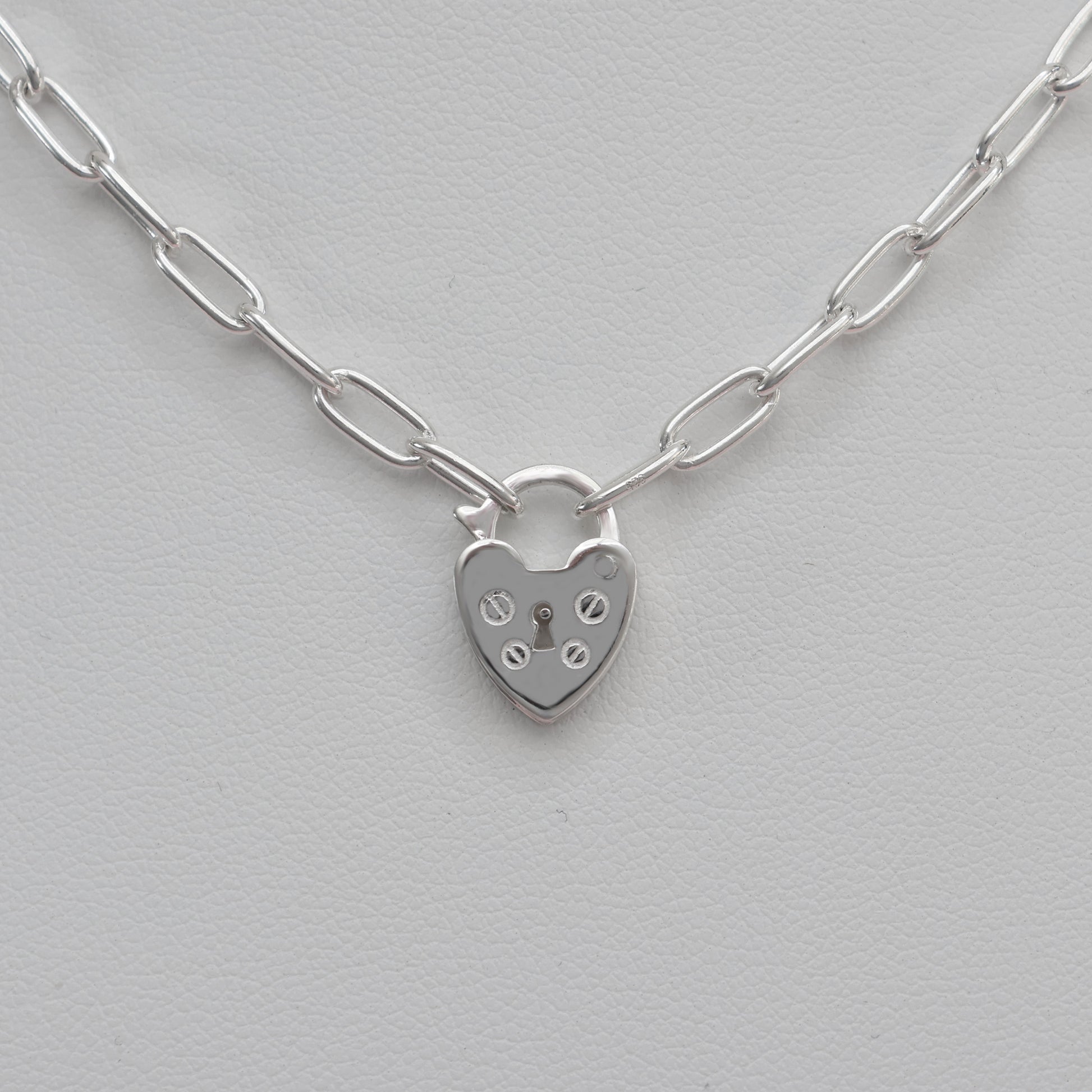 Stylish padlock clasp silver necklace featuring a heart-shaped design and bold link chain
