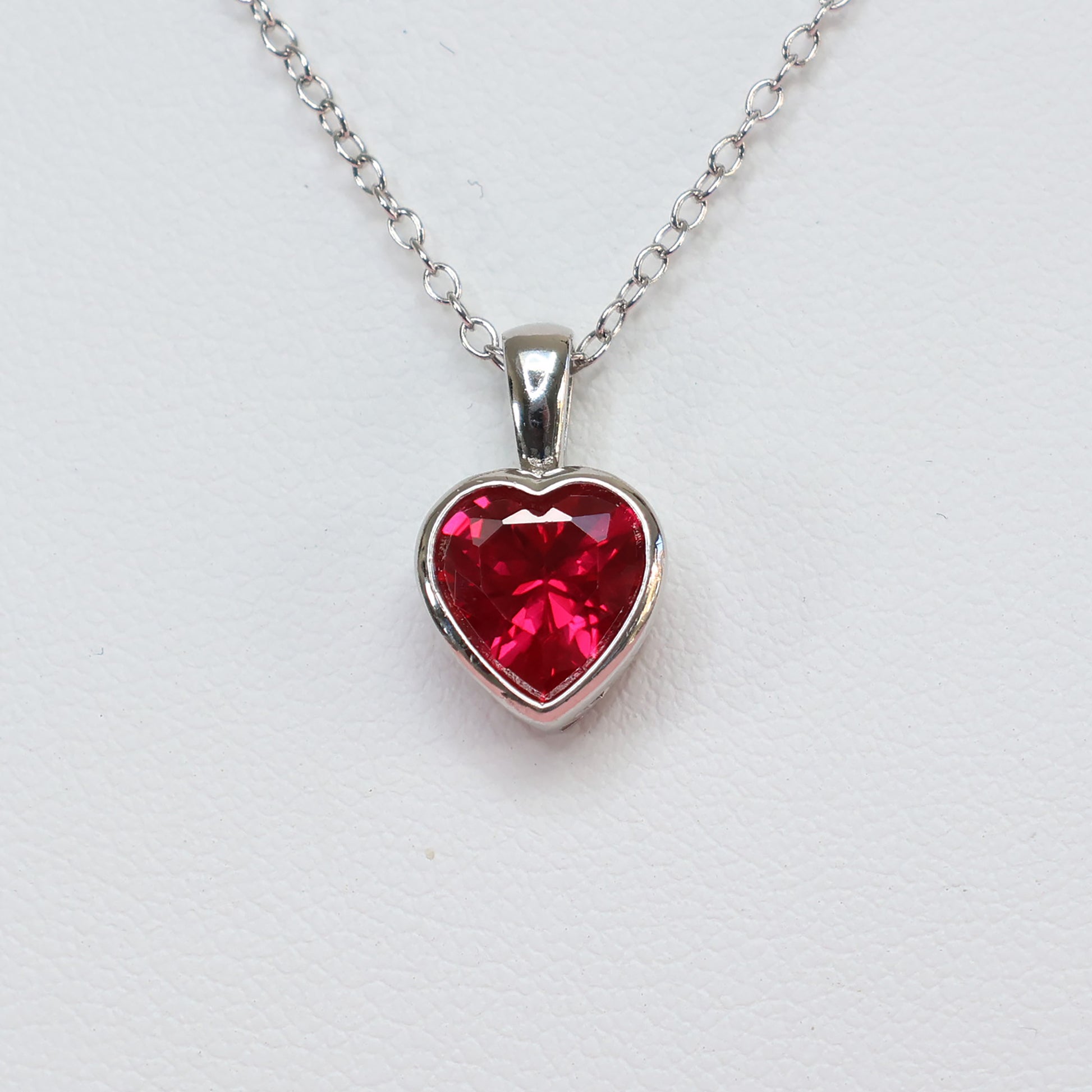 Red heart cubic zirconia pendant with a silver chain, perfect for adding elegance to any outfit