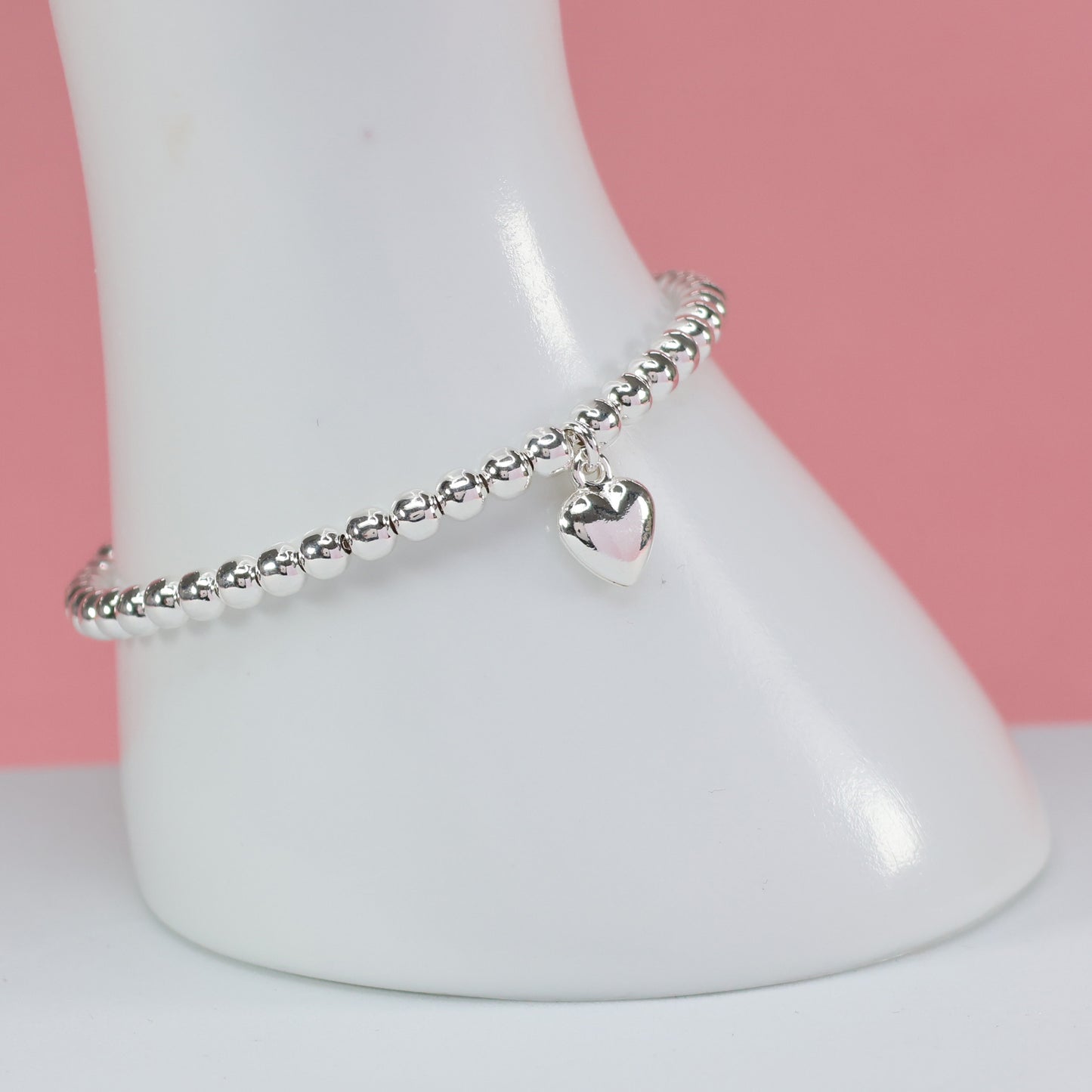 Elegant silver bead heart charm bracelet featuring a shiny heart pendant for stylish accessories