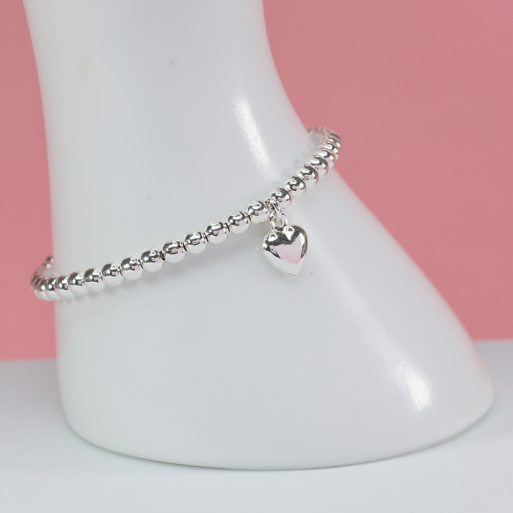 Elegant silver bead heart charm bracelet featuring a shiny heart pendant for stylish accessories