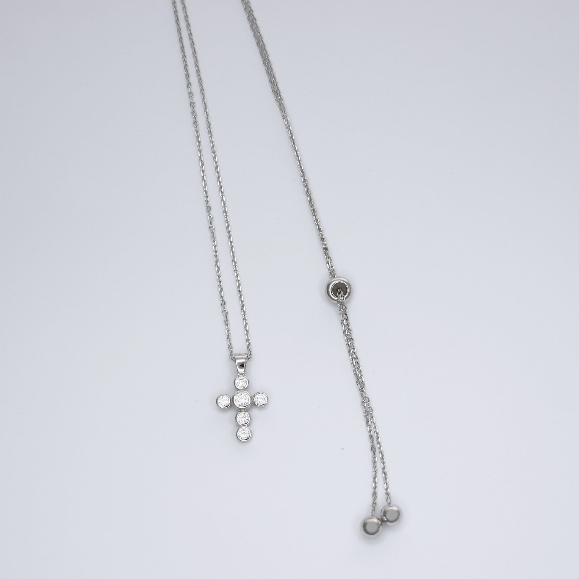 Elegant silver cross necklace for women featuring a delicate chain and sparkling embellishments