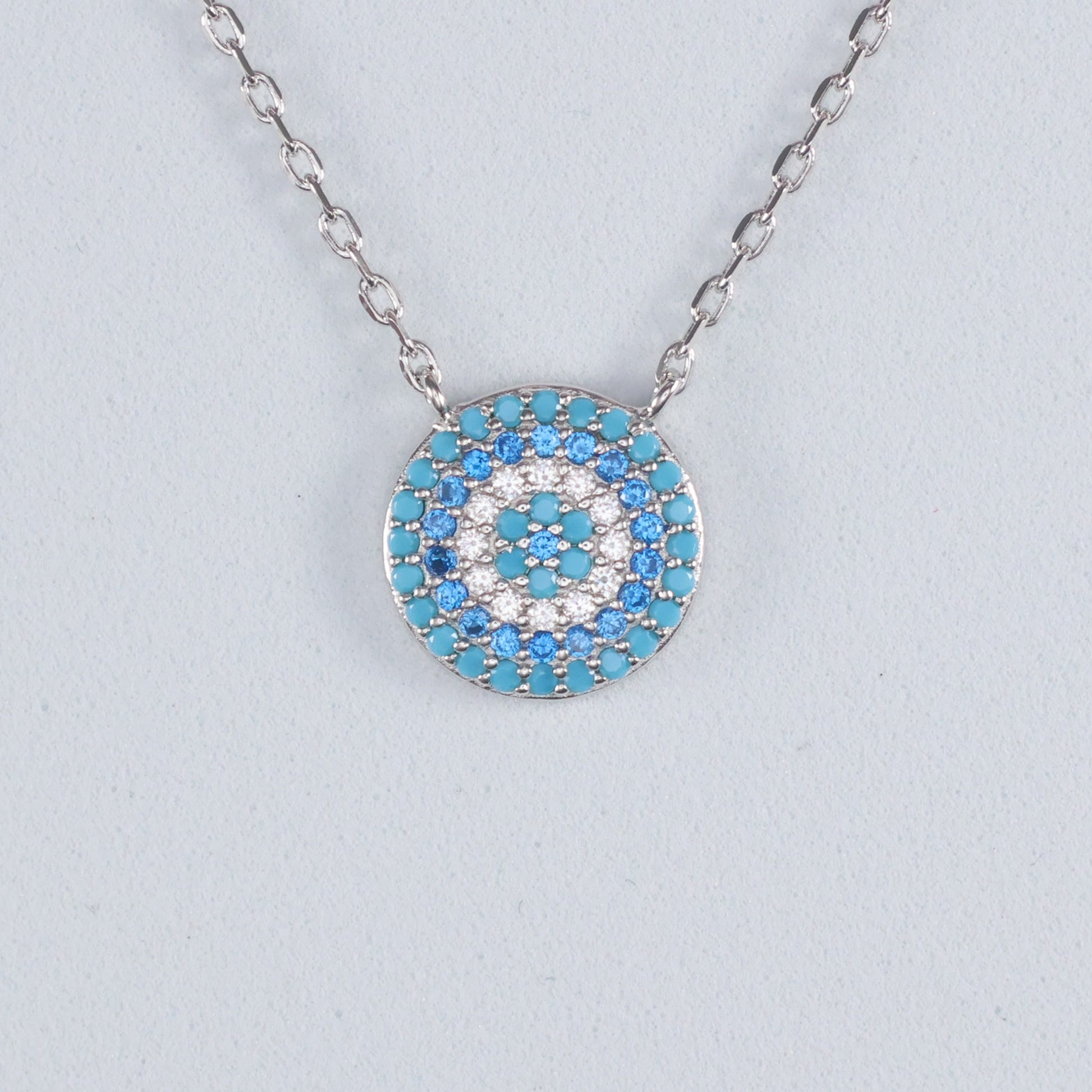 Silver Evil Eye Pendant with turquoise and white gemstones on a delicate chain