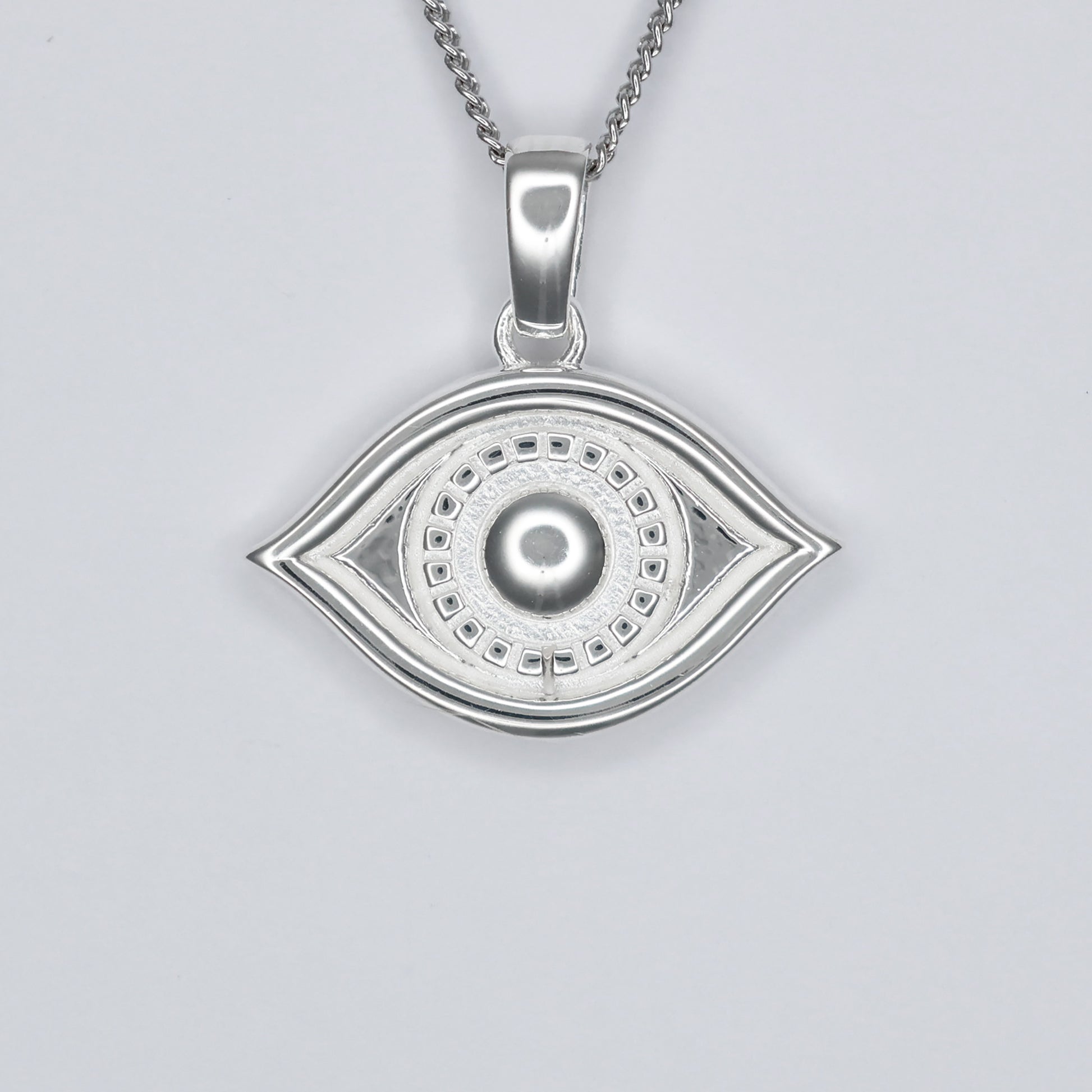 Elegant silver eye pendant necklace featuring intricate detailing and a polished finish