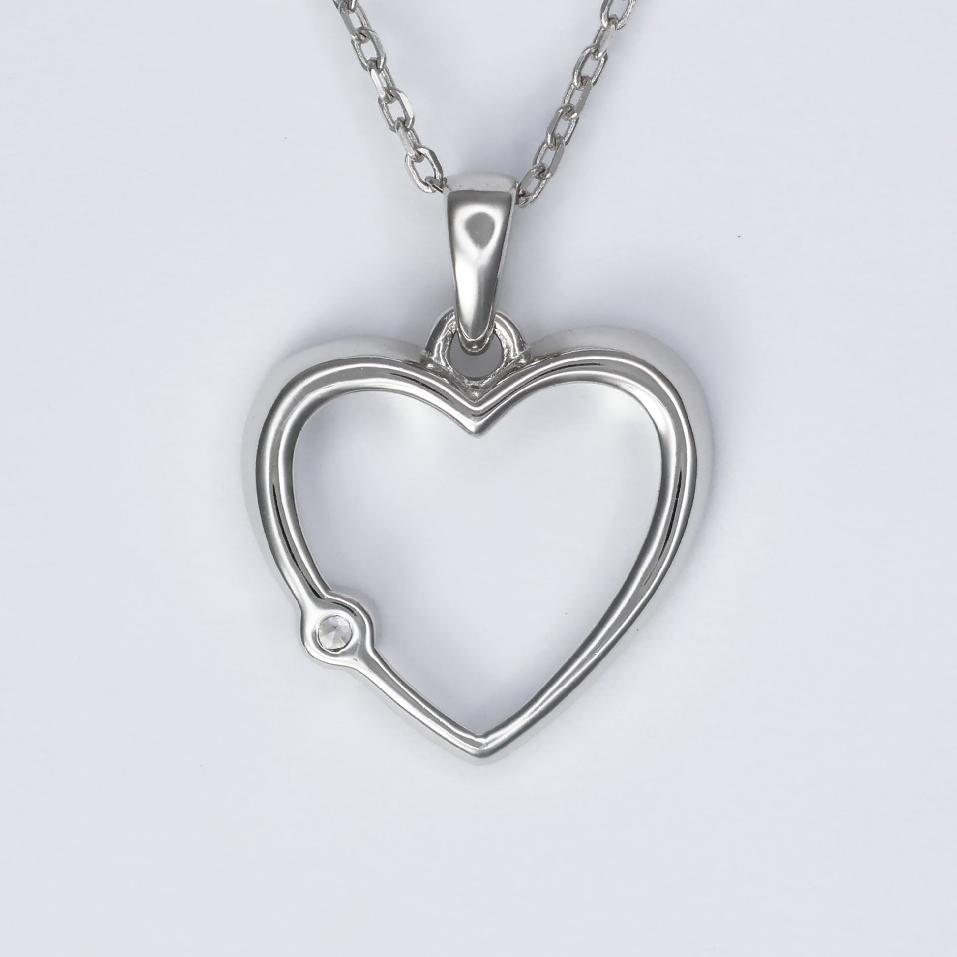 Stylish silver heart pendant for women with a sparkling gem detail on a delicate chain