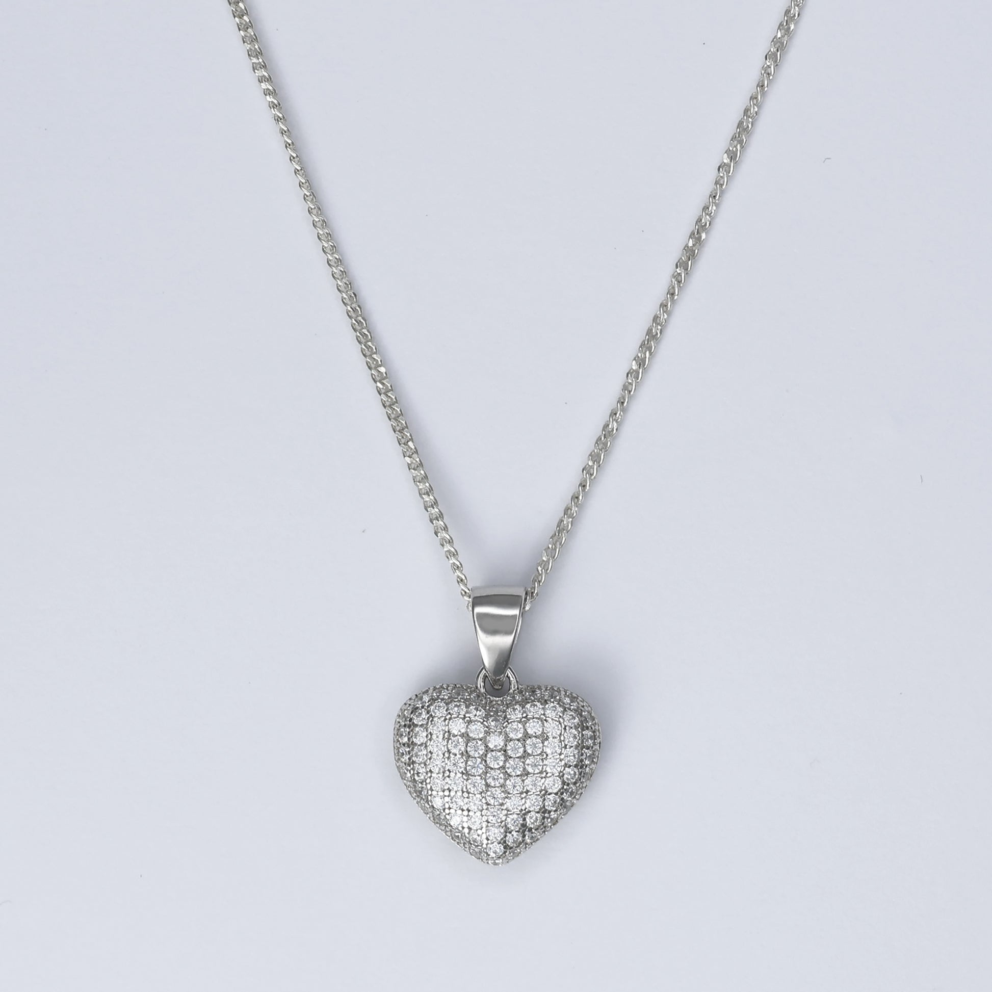 Silver Heart Pendant Necklace adorned with sparkling stones on a delicate chain