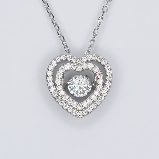 Silver heart pendant necklace featuring a sparkling center stone and intricate design for elegant style
