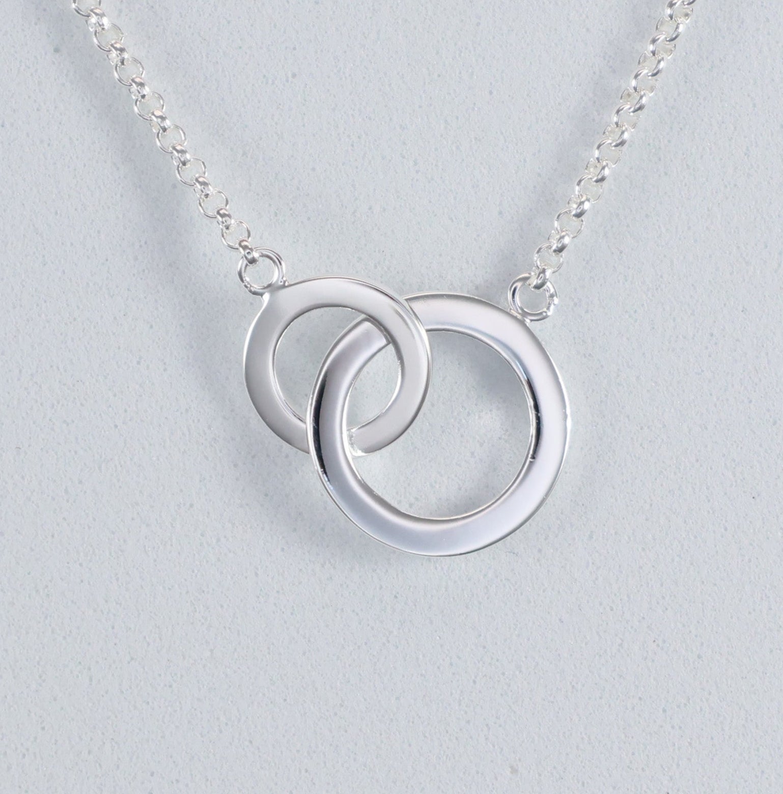 Stylish silver interlocking hoop necklace with a modern double hoop design
