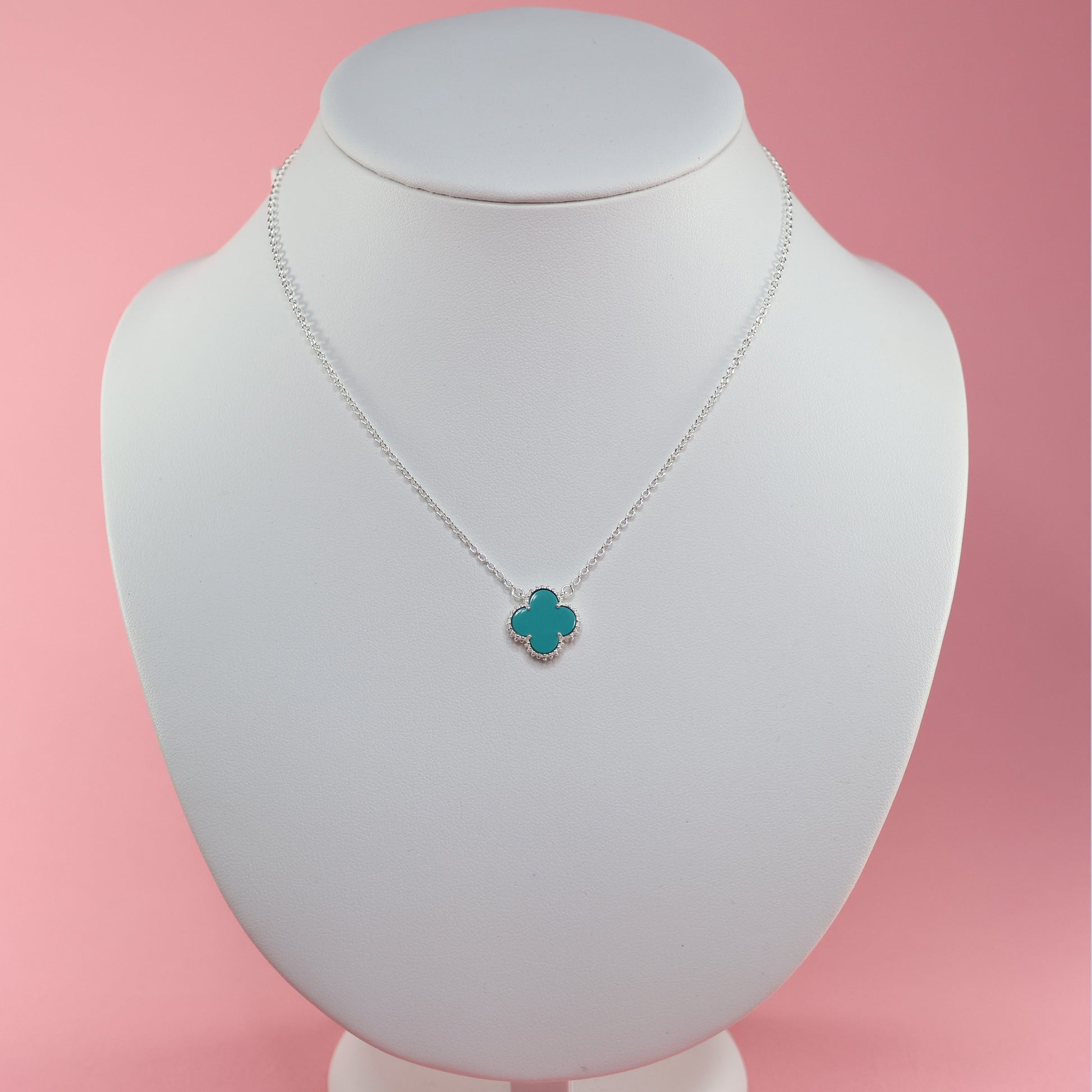 Delicate silver necklace with blue clover design, perfect for adding elegance to any outfit