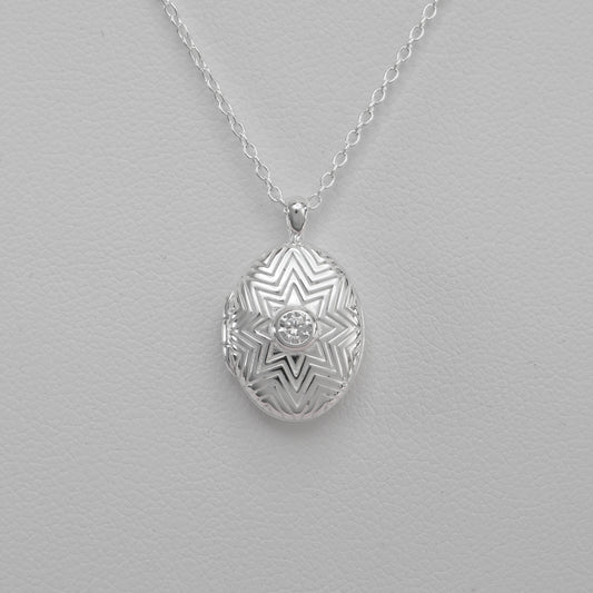 Intricate silver oval locket necklace with geometric design, perfect for personalized keepsakes