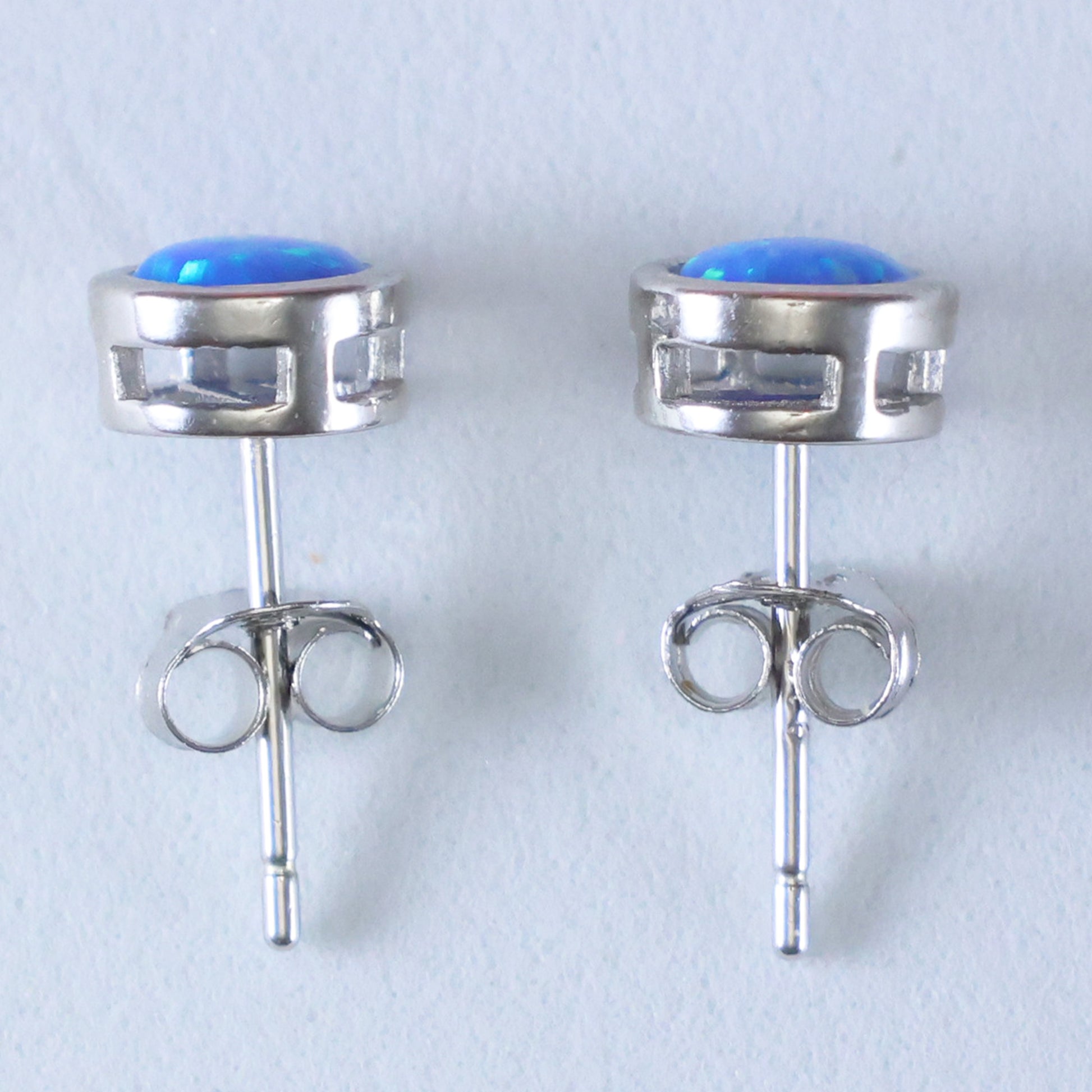 Stylish silver stud earrings for women with blue gemstone accents for a modern look