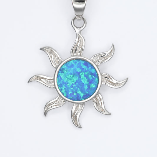 Silver sunshine pendant featuring a vibrant blue opal center and elegant sunray design