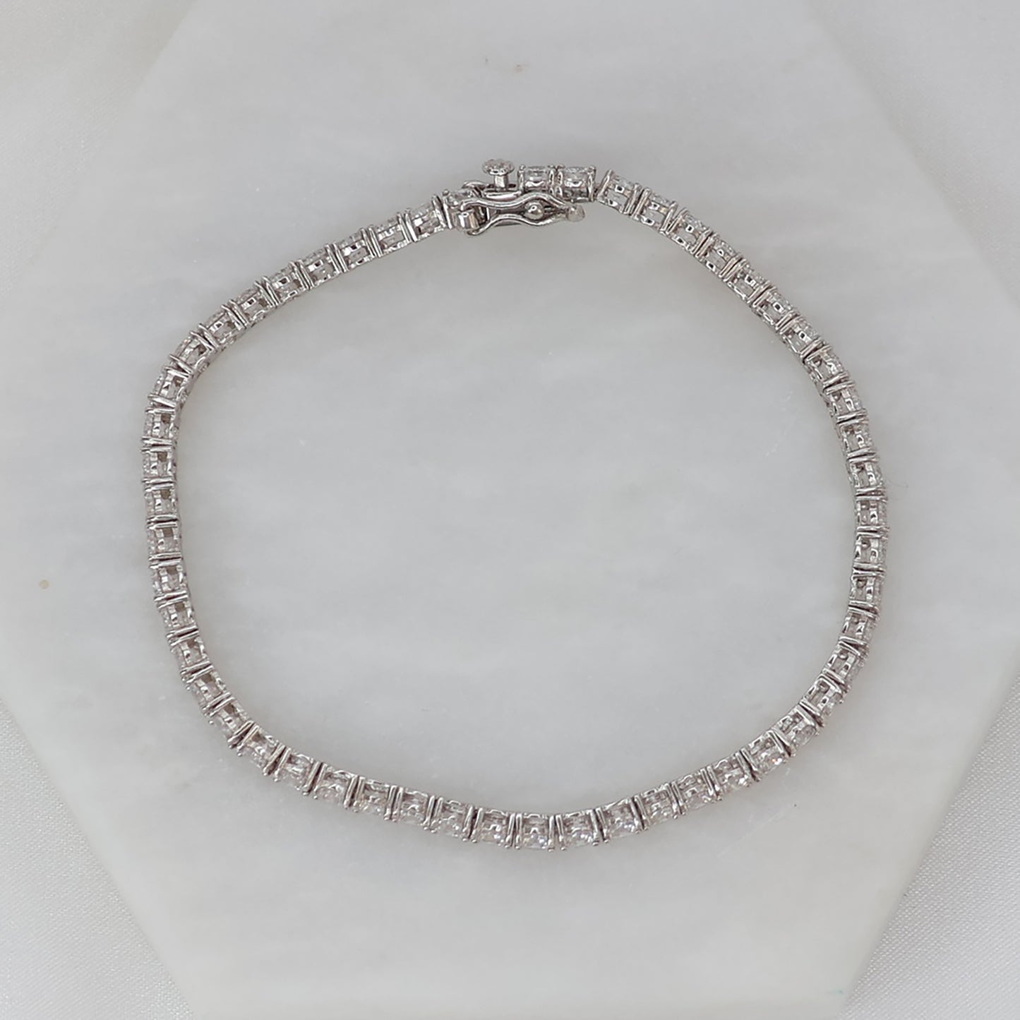 Elegant silver tennis bracelet featuring sparkling stones and a secure clasp from thejewelleryshop.co.uk