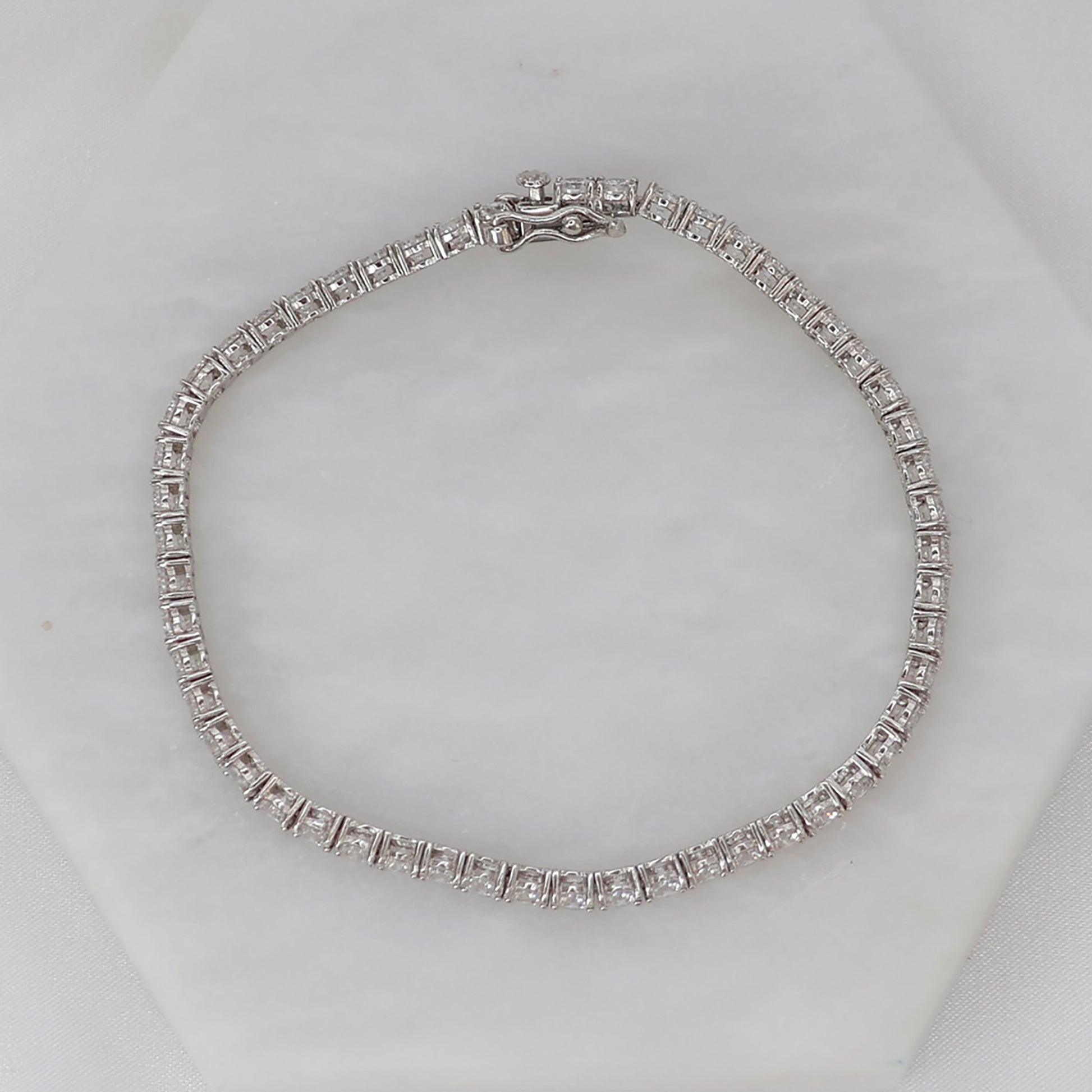 Elegant silver tennis bracelet featuring sparkling stones and a secure clasp from thejewelleryshop.co.uk