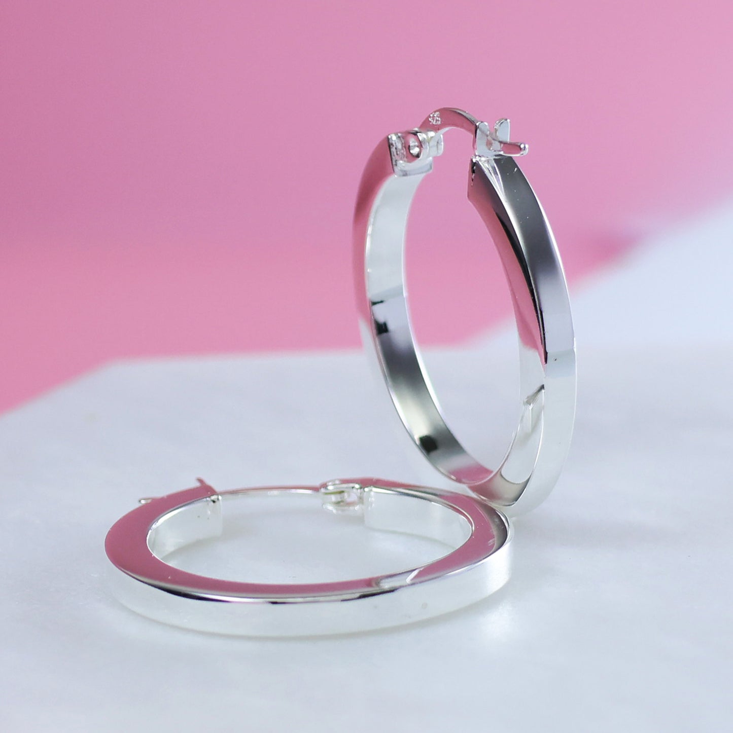 Sterling silver hoop earrings with a sleek and polished design for everyday elegance
