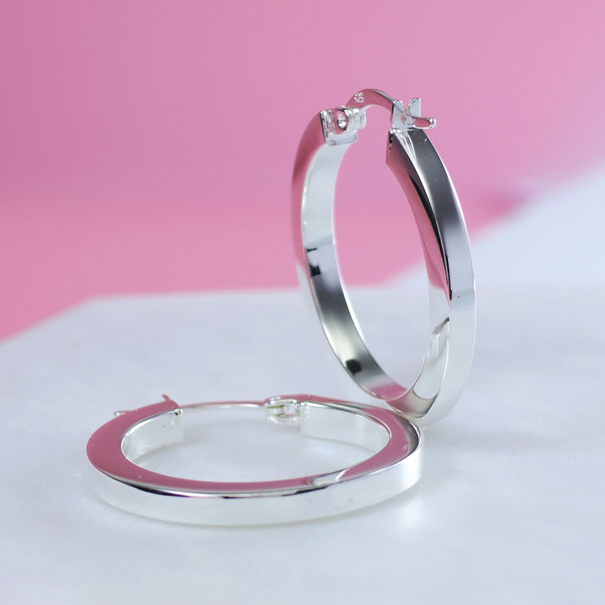 Sterling silver hoop earrings with a sleek and polished design for everyday elegance